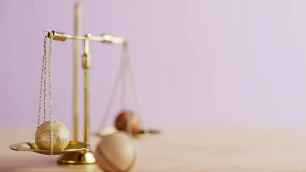 A gavel resting on a desk next to a stack of legal documents and a smartphone